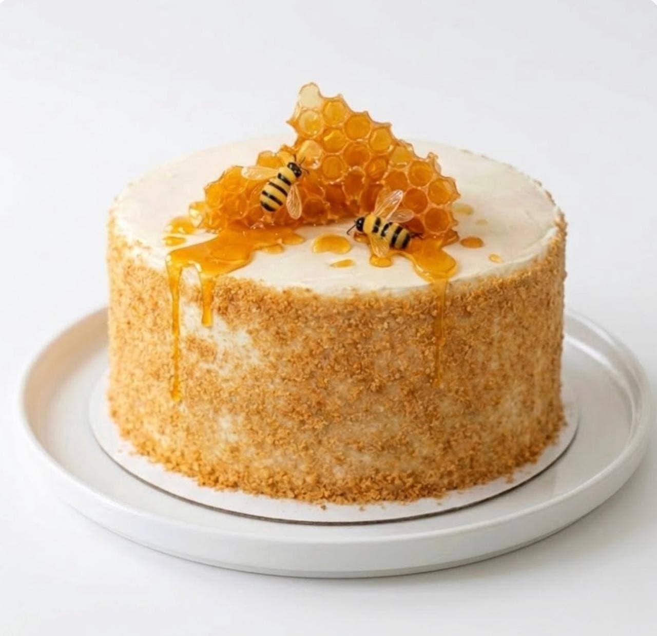 Handcrafted honey cake with real honeycomb, honey drips and chocolate bees