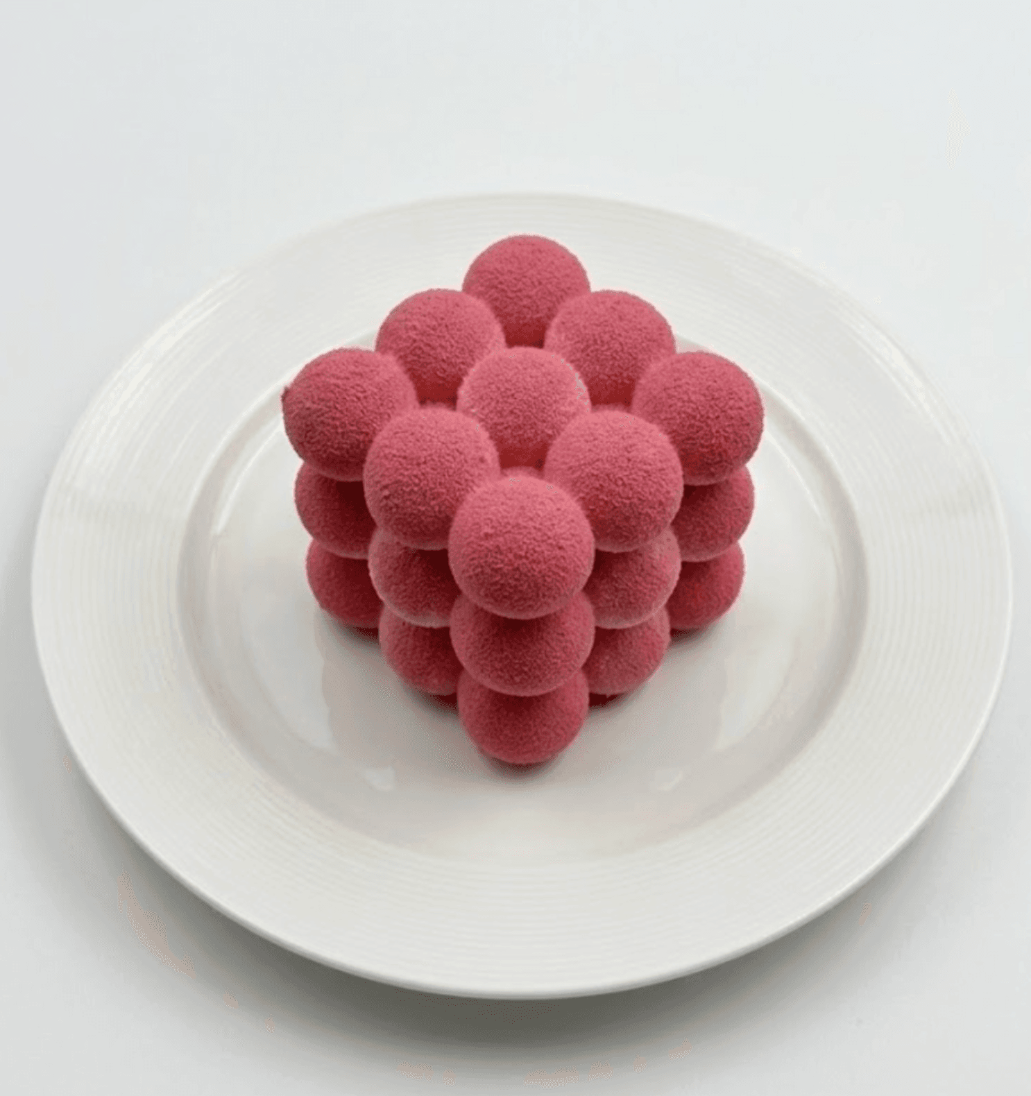 Pink spherical berry mousse dessert — artisan confectionery
